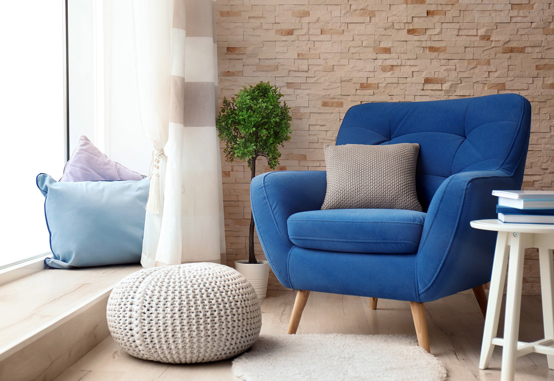 Blue armchair with cushion and side table