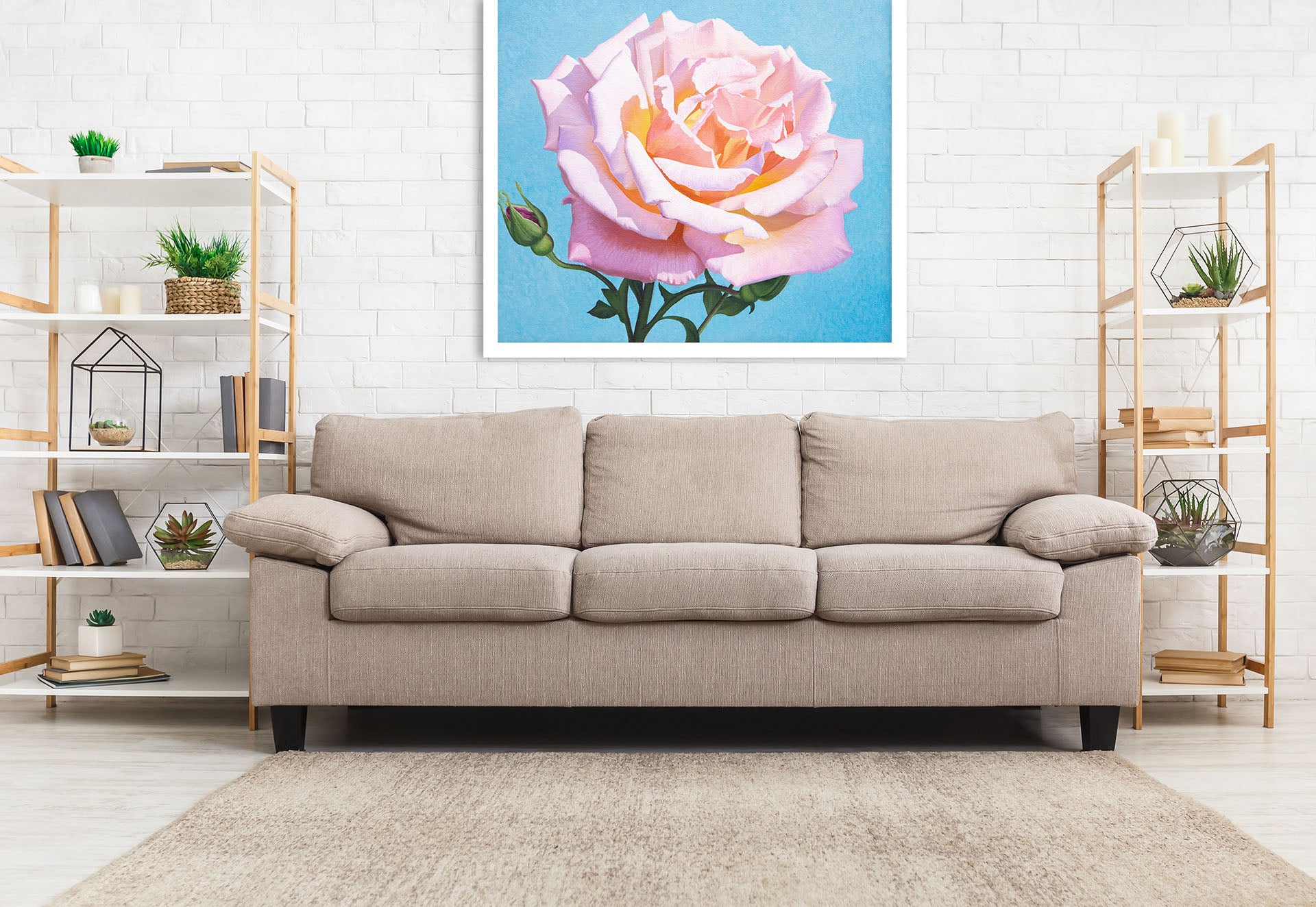 three person sofa next to small wooden bookcases and wall art in backgroun