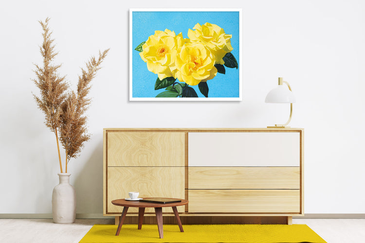 Wooden sideboard with three drawers and wall art in background