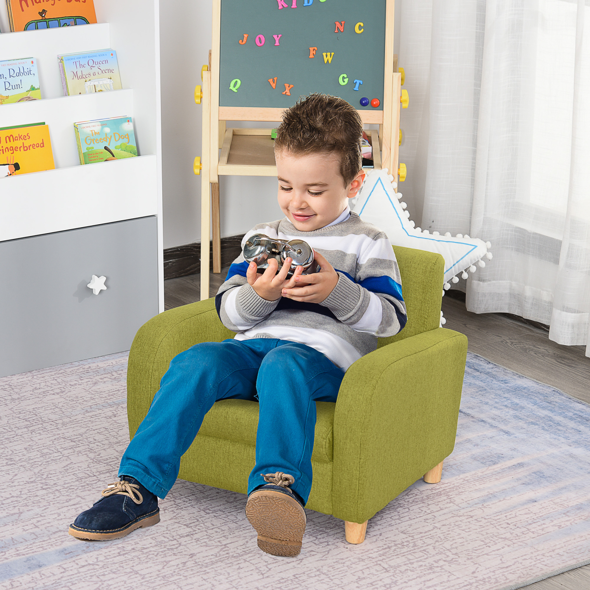 Child sits in a green wood-frame armchair with padded seat in a kids' bedroom, playing with a toy car.