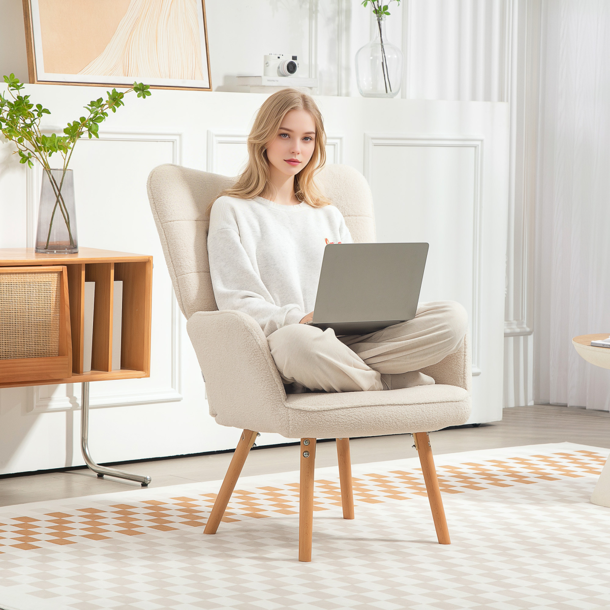 Woman seated in HOMCOM Tufted Wingback Armchair Medium Fleece Seat LivingRm with laptop on lap.
