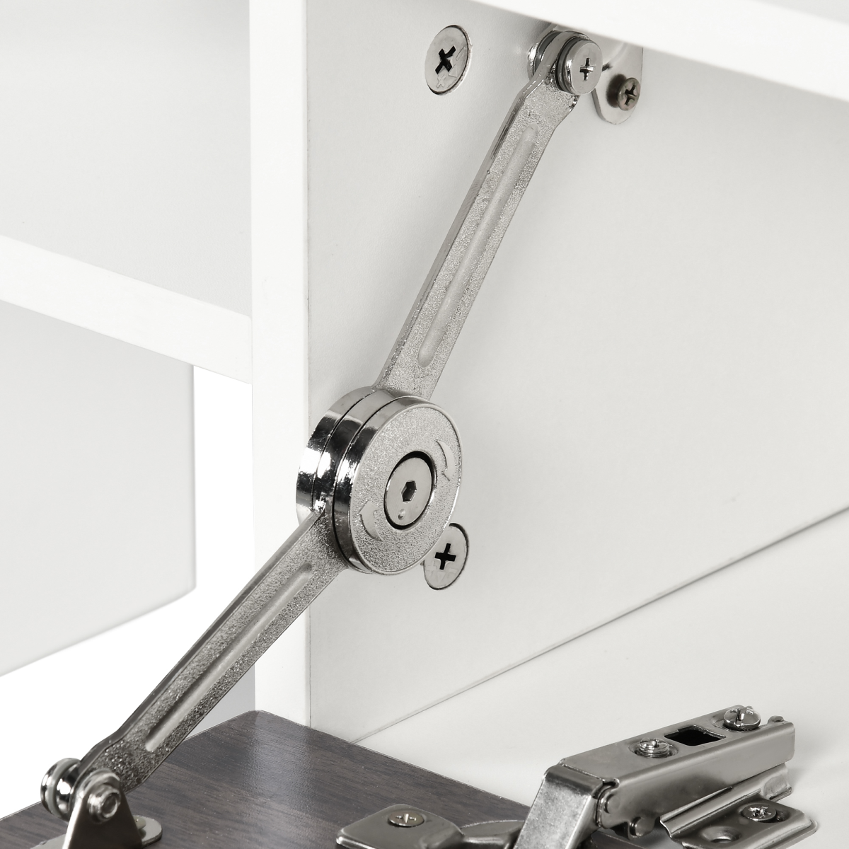 Close-up of metal hinge and arm on a white TV cabinet with hidden storage