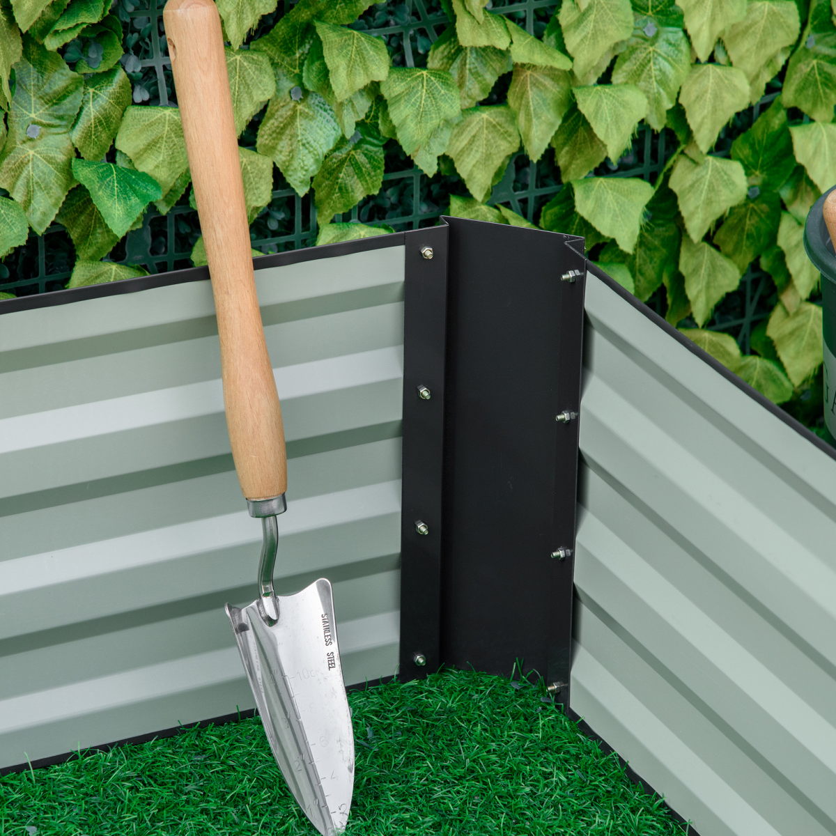 Outsunny 120x80cm raised garden bed, galvanized steel planter with open bottom, trowel resting beside green turf.