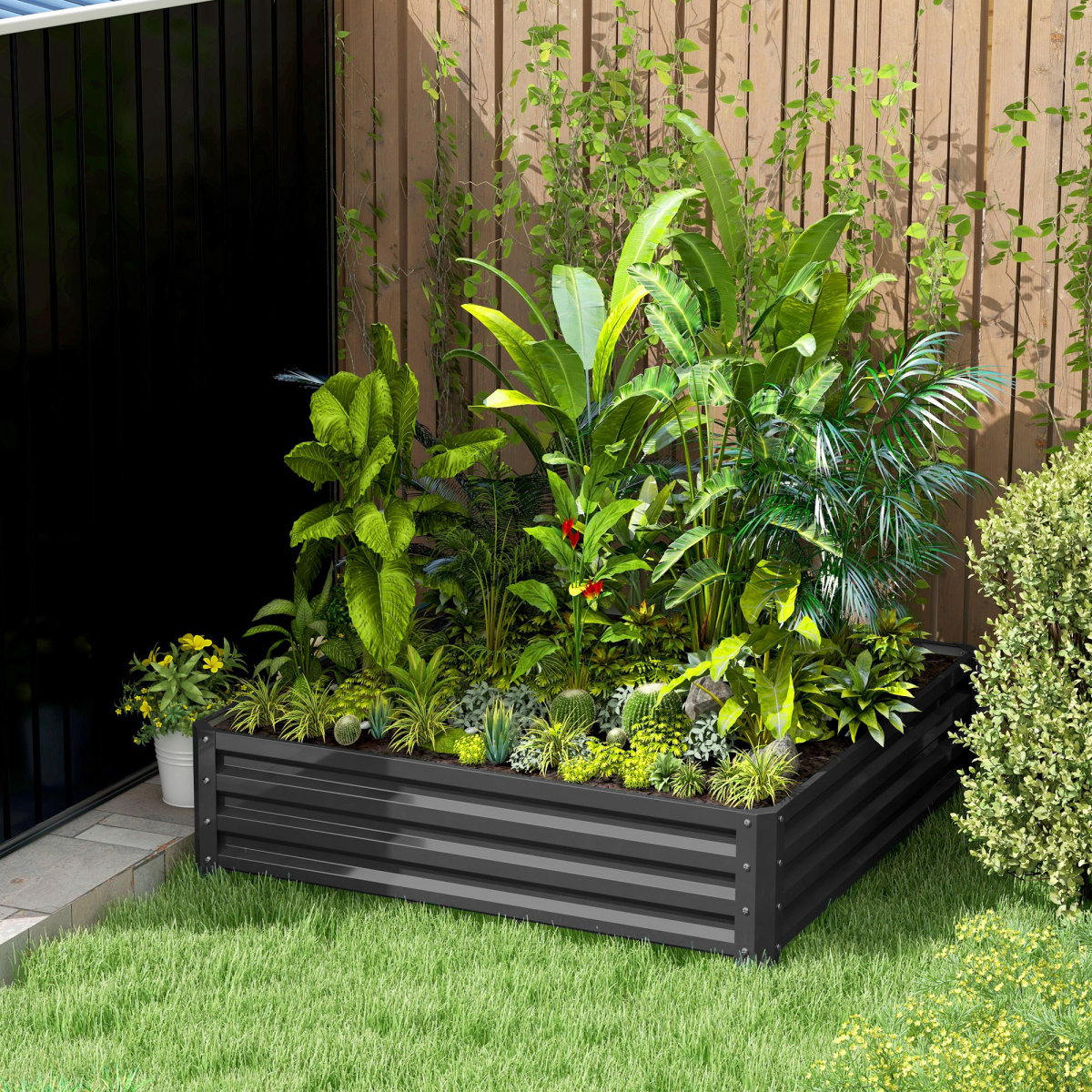 Outsunny 30cm galvanised steel raised garden bed filled with lush tropical plants in a backyard.