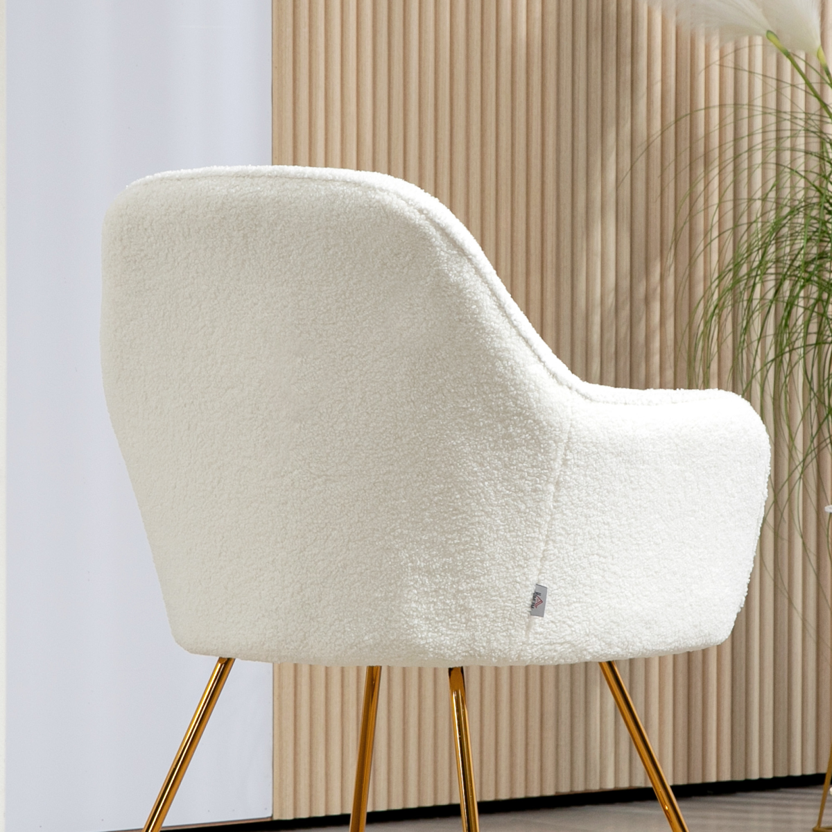 Cream cashmere upholstered chair with gold legs, high back, compact modern design.