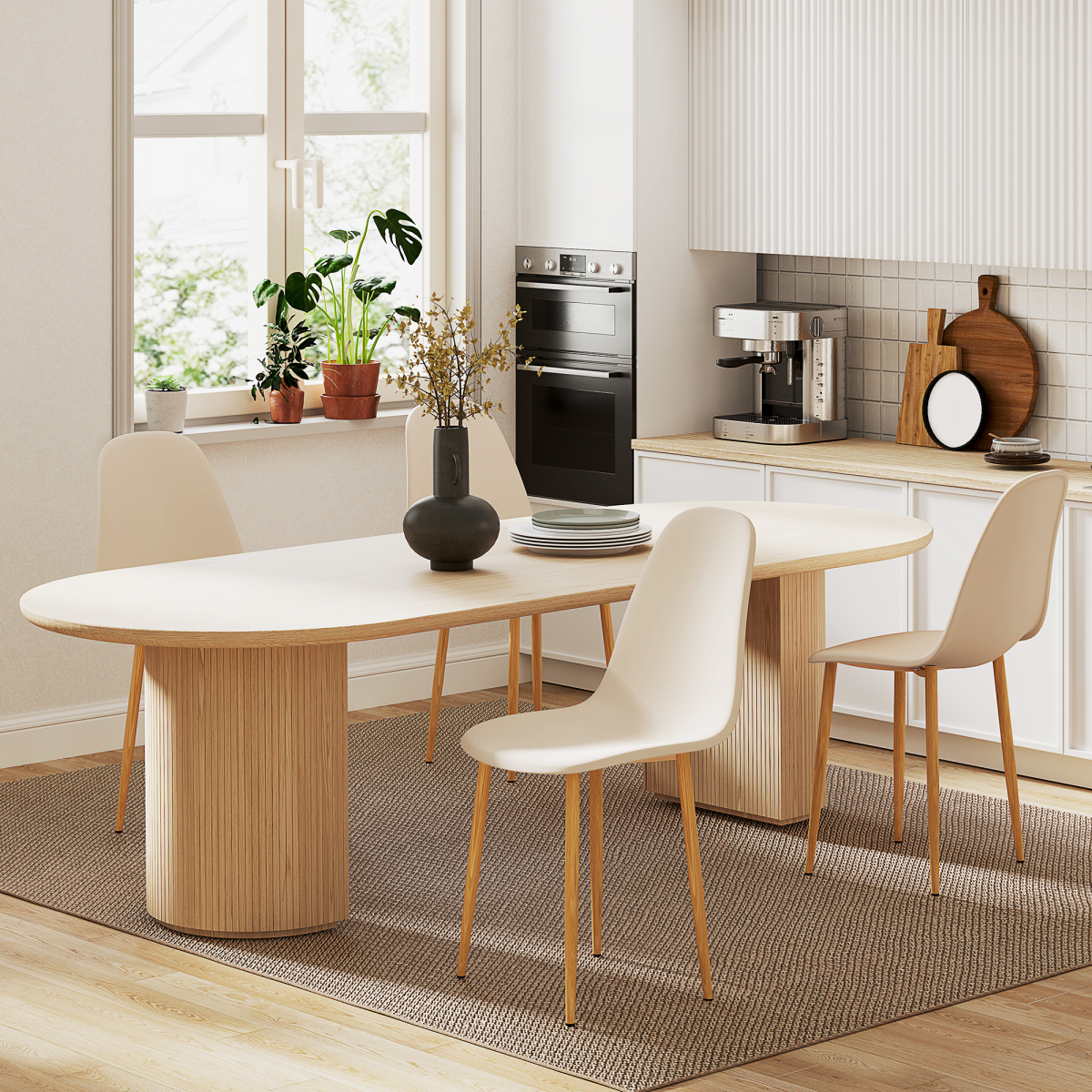 Four cream dining chairs with natural wooden legs surround a light oak oval table in a bright kitchen.