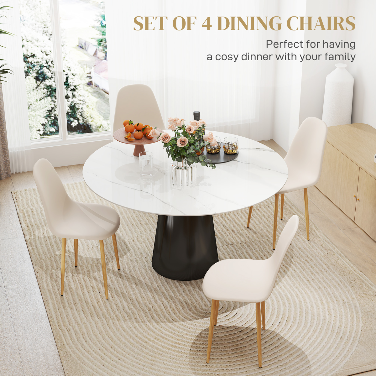 Set of four cream dining chairs with wooden legs around a round marble dining table in a bright modern dining room.