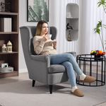 HOMCOM Wingback Chair 70cm High Velvet Comfort Living Room: a woman relaxing in a gray velvet wingback chair.