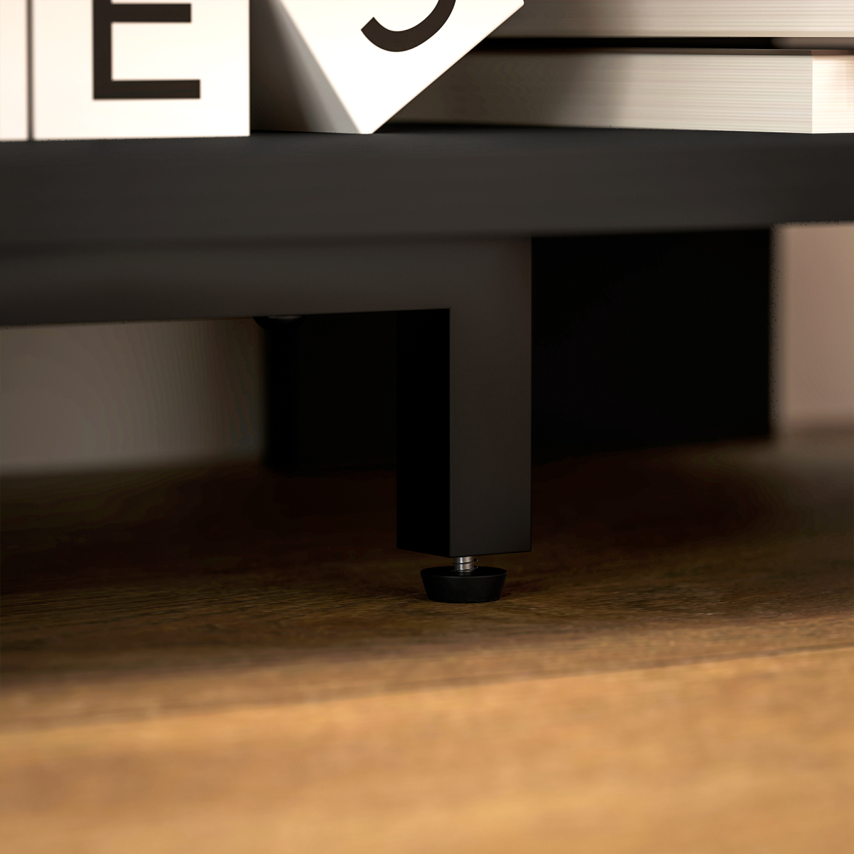 Close-up of HOMCOM corner TV stand leg with adjustable leveling foot on wooden floor