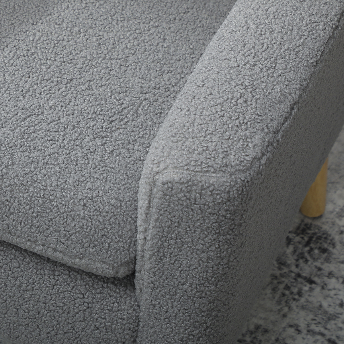 HOMCOM Accent Chair Wide Seat Teddy Fleece For Living Room close-up of plush grey upholstery and wooden leg.