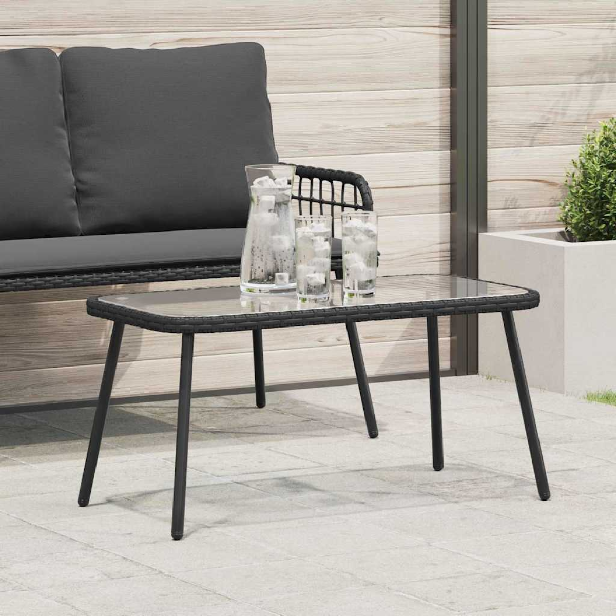 VidaXL Coffee Table 90 x 45 x 42 cm Poly Rattan Outdoor with glass top on a patio beside a grey outdoor sofa.