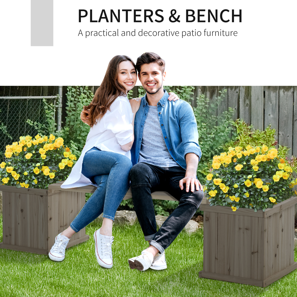 Couple sits on a wooden garden planter bench with dual raised planters and yellow flowers on a lawn.