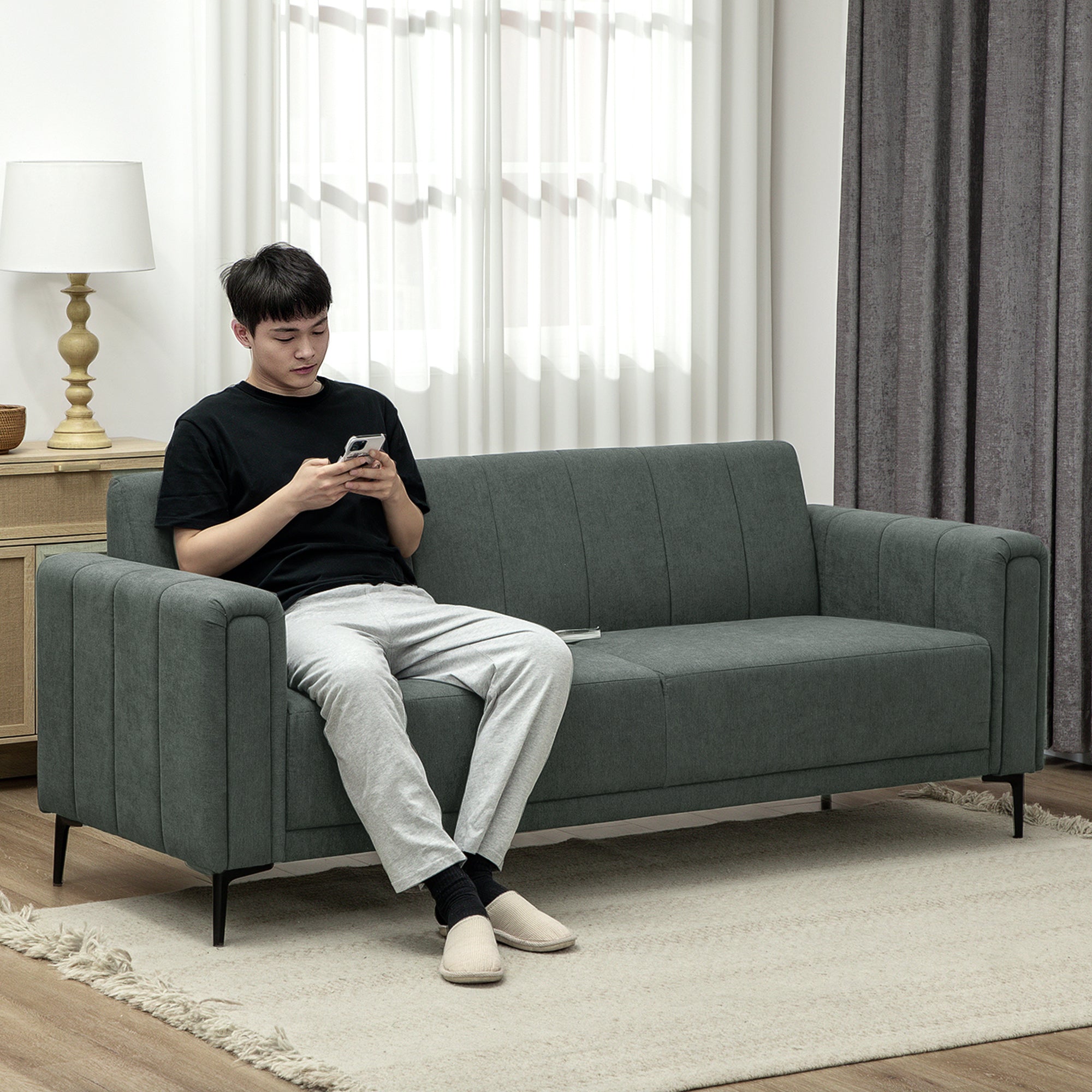 HOMCOM Three Seater Sofa Full Size Channel Tufted For Home in a modern living room with a man seated.