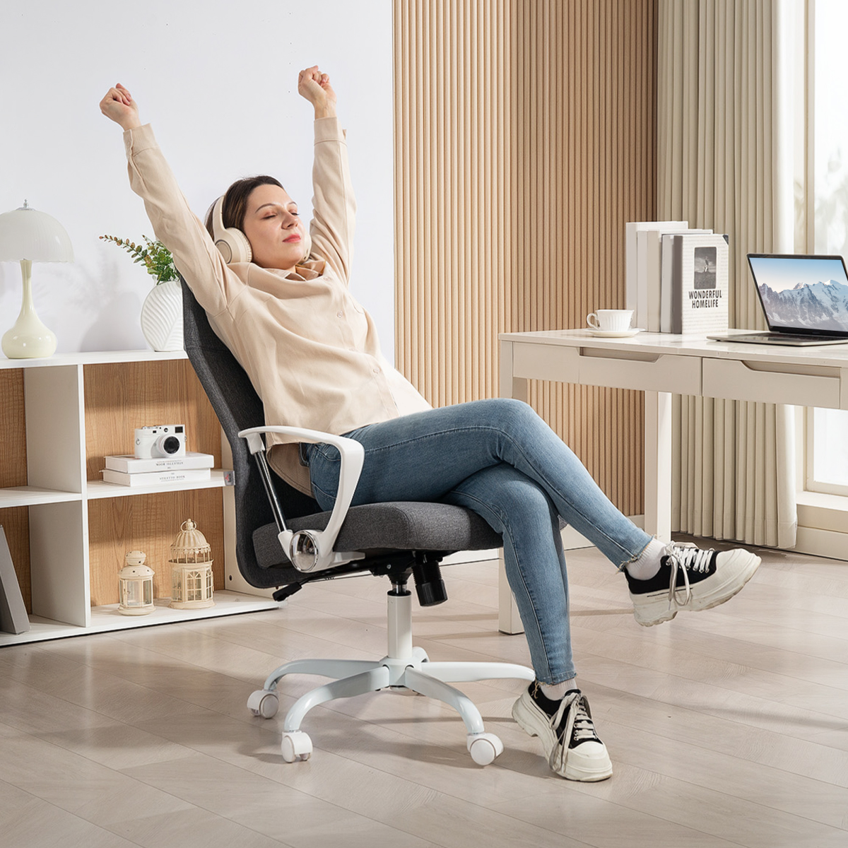 HOMCOM High Back Office Chair Adjustable Tilt For Home in a modern home office with a person stretching at the desk.