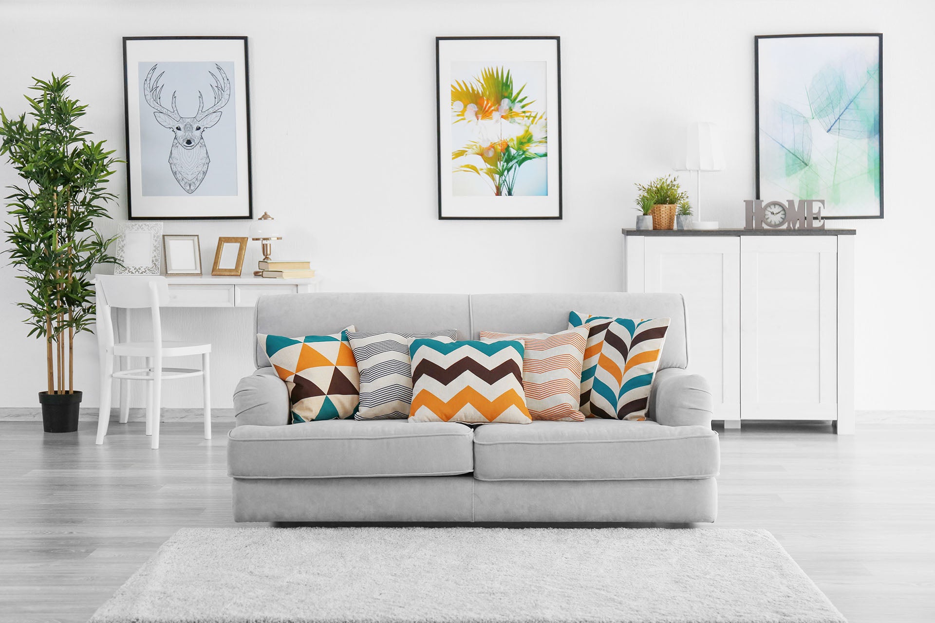 grey sofa and with matching pillow set, modern white living room and wall art