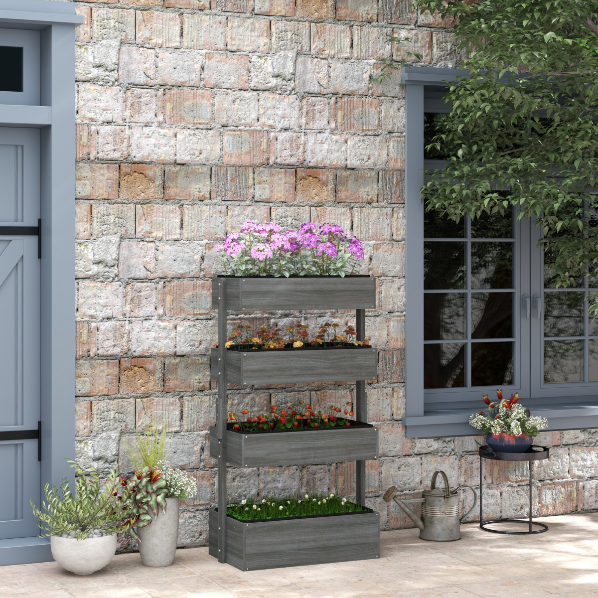 Galvanized four-tier outdoor planter tower with separate soil boxes on a patio beside a brick wall