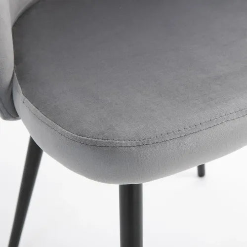 Close-up of a gray upholstered chair with sleek black metal legs, armless design, and a smooth, rounded seat. The 2 Pieces Modern Upholstered Fabric Bucket Seat Dining Chairs Living Room Grey by Unbranded features velvet-feel upholstery positioned on a white surface.